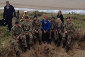 Royal Navy Southern Diving Group and DIO EOC staff pose with Countryfile presenters Ellie Harrison and Matt Baker on Whitsand Beach, the Gower, Wales. (Crown Copyright)