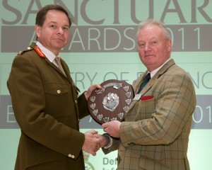 A Cape Wrath Training Centre representative collects the Heritage Project award at Sanctuary Awards in 2011. [Crown Copyright]