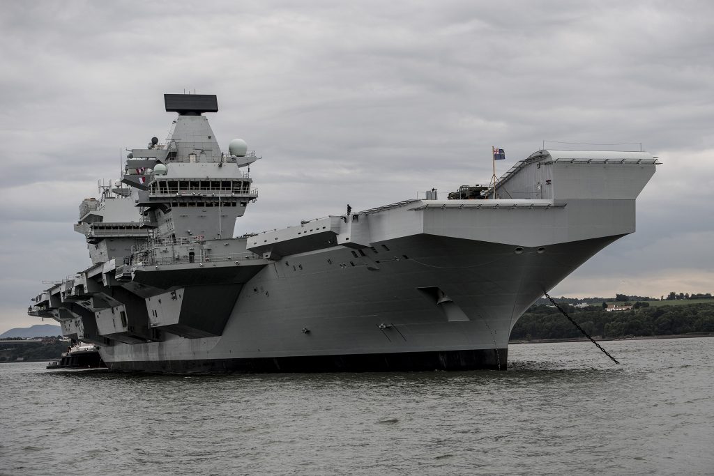 HMS Queen Elizabeth under anchor awaiting low tide before departing. [Crown Copyright/MOD2017]