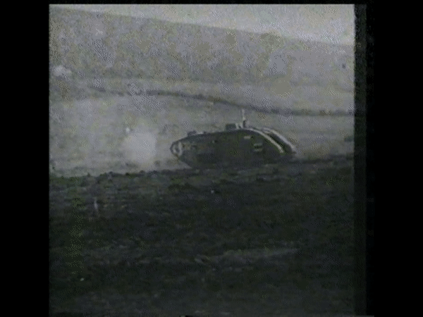 Black and white footage showing World War One tanks moving driving across open fields and firing their weapons.