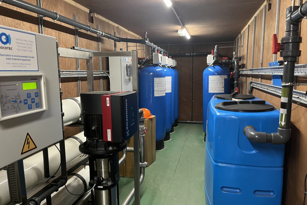 An image taken inside the new water treatment plant, showing various machinery, equipment and pipework along the walls.