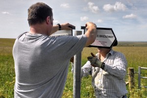 Volunteers erecting signs showing a permissive bridleway. (Crown Copyright)