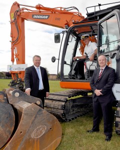 Project Director from Carillion, Trevor Pratt; Commanding Officer of RNAS Yeovilton, Commodore Jock Alexander, and DIO Deputy Head Manager Projects West, Matt Harris with a mechanical digger.