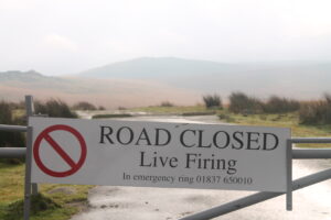 A sign informing the public that the road is closed due to live firing. [Helen Pickering; Crown Copyright/MOD2014]