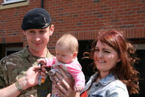 The keys for L/Cpl Neely and his wife's new home are handed to their daughter (Helen Pickering, Crown Copyright/MOD 2015)