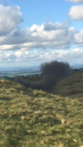 Smoke rises from the destroyed shell. 