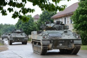 Soldiers in armoured vehicles training at Copehill Down Village. [Landmarc Support Services 2015]