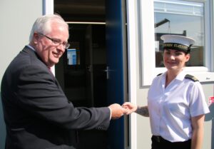 Leo O'Shea, DIO's Director of Service Delivery, hands over the key to her new cabin to AB Leanne Roberts. [MOD/Crown Copyright 2015]