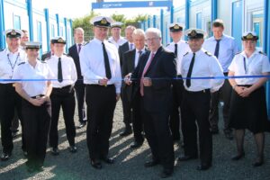 Leo O'Shea, DIO's Director of Service Delivery, and Cdr Mark Hugesdon cut the ribbon at the handover of the first tranche of modular accommodation. [MOD-CrownCopyright2015].