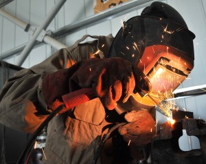 A Lance Corporal in the REME (Royal Electrical Mechanical Engineers) is pictured welding a vehicle component in Afghanistan. [MOD/Crown Copyright2012]