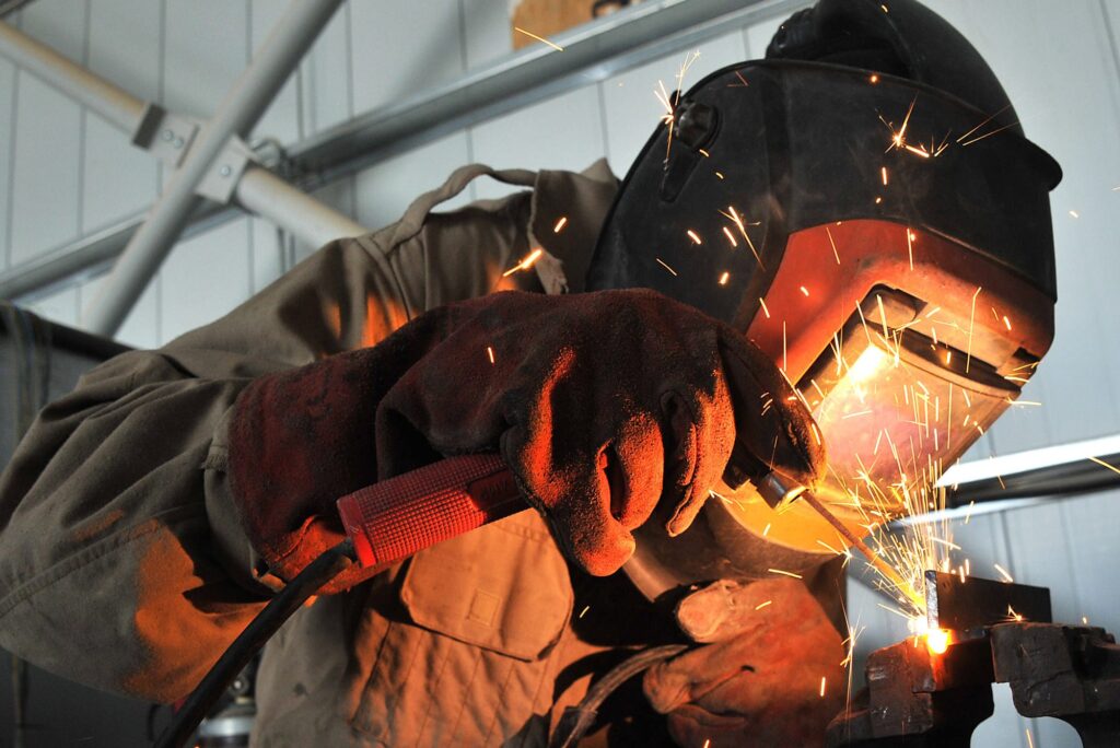 A Lance Corporal in the REME (Royal Electrical Mechanical Engineers) is pictured welding a vehicle component in Afghanistan. [MOD/Crown Copyright2012]