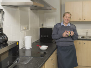 Flt Sgt Kerry Finlay in her new accommodation in the Sgt Mess at RAF Wyton, built under Project SLAM. [Crown Copyright]