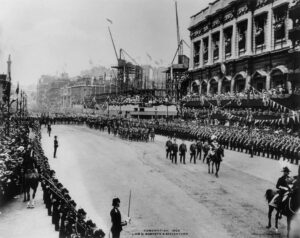 The procession for the coronation of King Edward VII passes the construction of The Old War Office building in Whitehall, London in 1902.