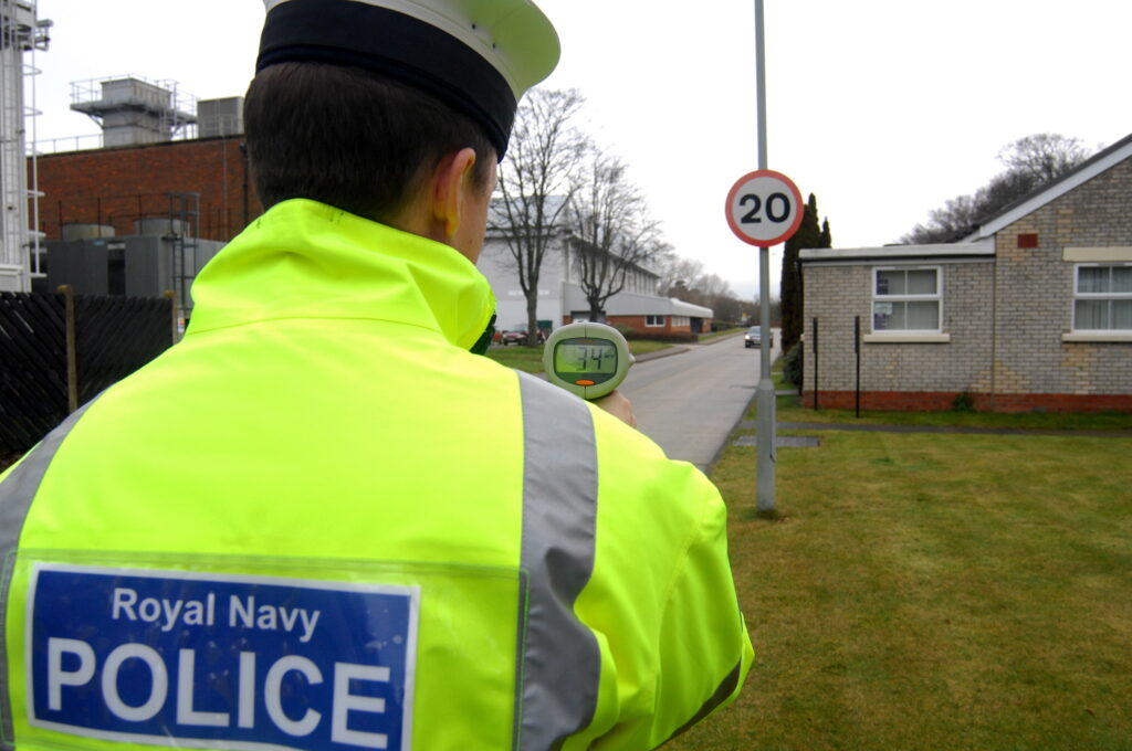 A member of the Royal Navy Police is pictured carrying out a vehicle speed check at HMS Sultan in Gosport, Hampshire.