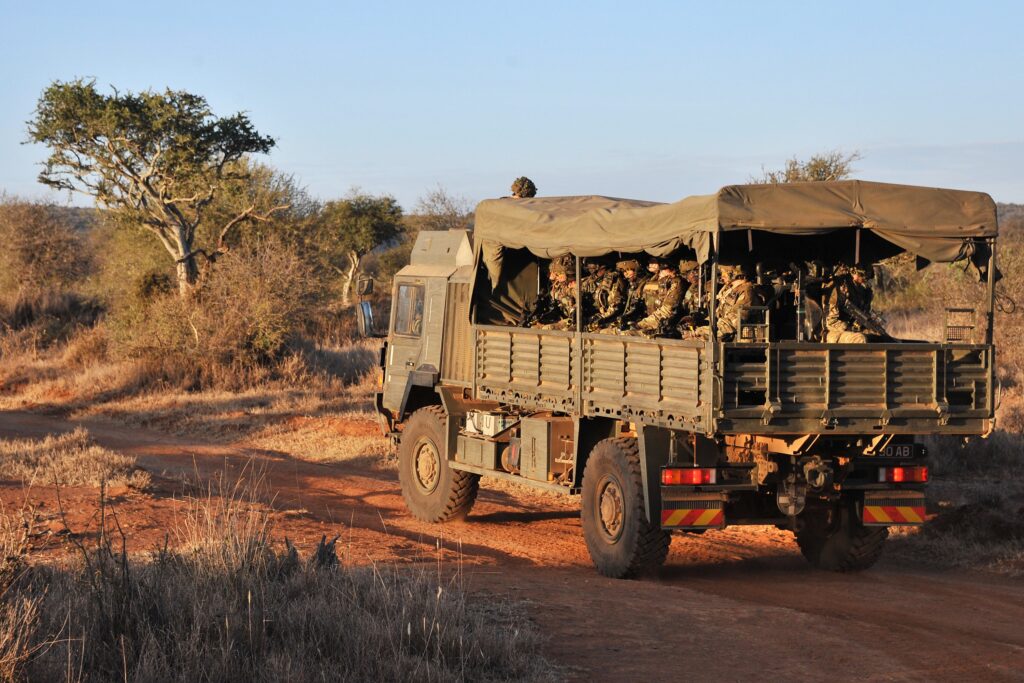 A Troop Carrying Vehicle being used to transport soldiers along a dirt road in Kenya. 