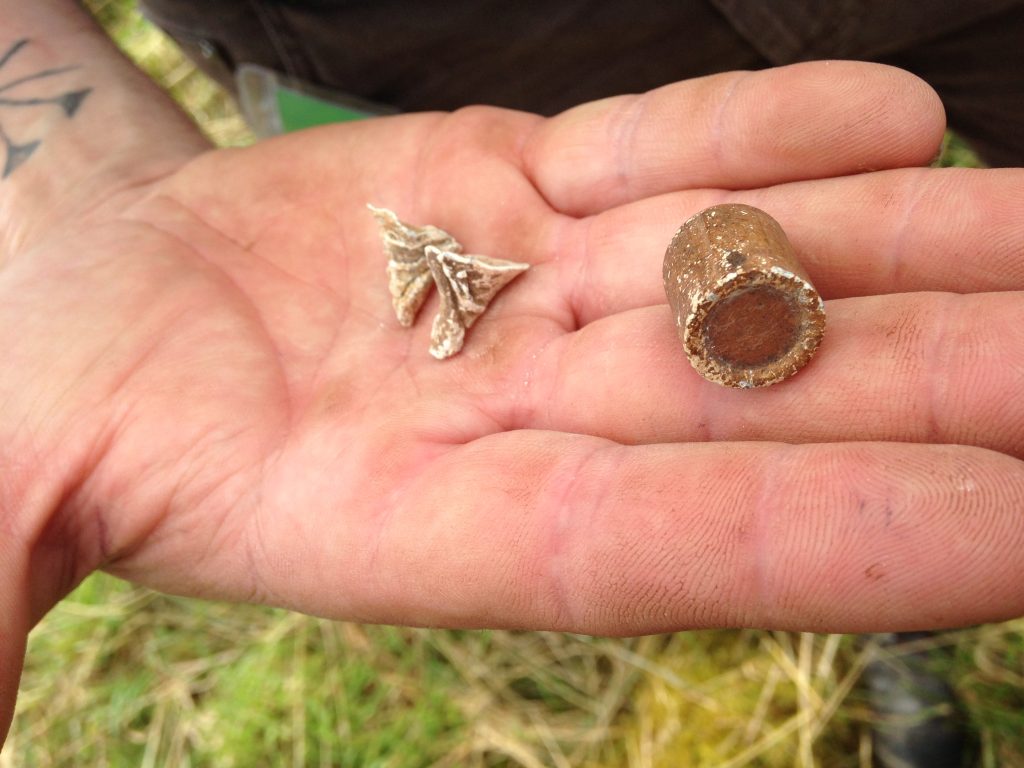 Bullet 'splashes' and a suspected Martini Henry bullet from the time of the Zulu War, found during the excavations. [Crown Copyright/MOD 2017]