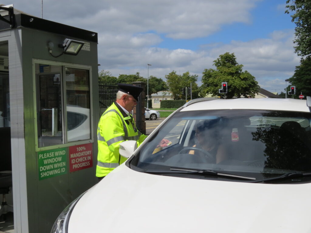 An MGS guard checking an ID pass before allowing entry to an MOD site. [Crown Copyright/MOD]