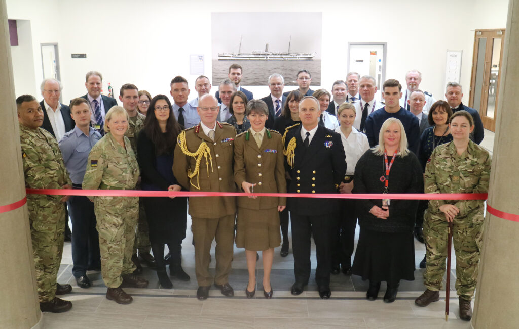 Colonel Katherine Richardson, Commanding Officer of the Royal College of Defence Medicine, cuts the ribbon to open the Glenart Castle Mess. She is accompanied by Major General Martin Bricknell, Acting Surgeon General, Surgeon Commodore Andrew Hughes, Commander Defence Medical Group, and representatives from the Surgeon General's Headquarters, DIO, and others. [Crown Copyright/MOD2017]