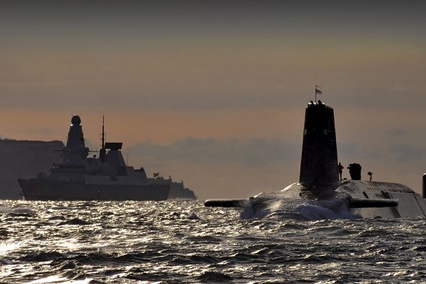 Nuclear submarine HMS Vanguard, above the surface, with HMS Dragon in the background. [Crown Copyright, MOD]