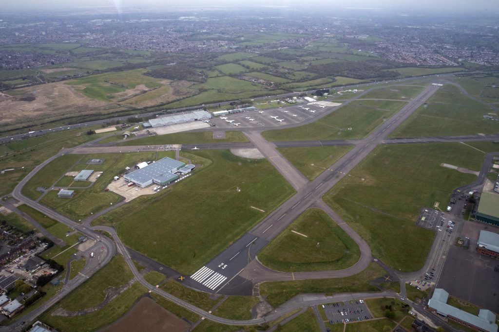 A view of RAF Northolt from the air, showing the main runway and a number of buildings. 