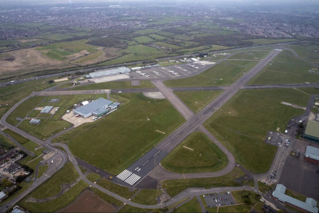 RAF Northolt from the air, with the main runway and various buildings visible.