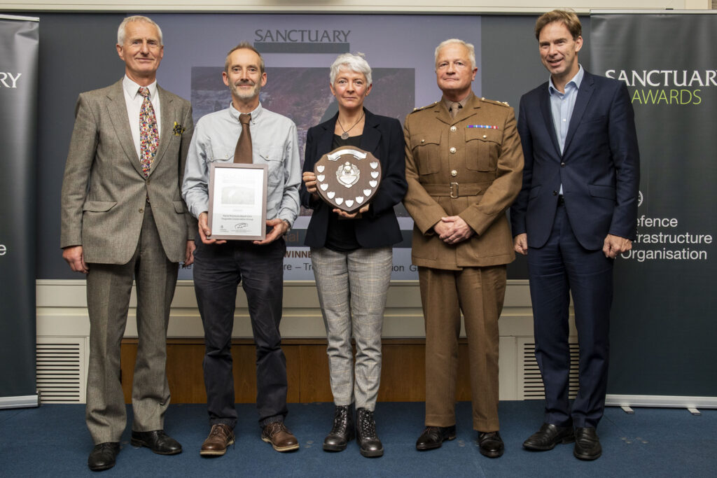 Representatives of the Rame Peninsula Beach Group pose with their award and Minister of Defence Personnel and Veterans, Tobias Ellwood MP. 