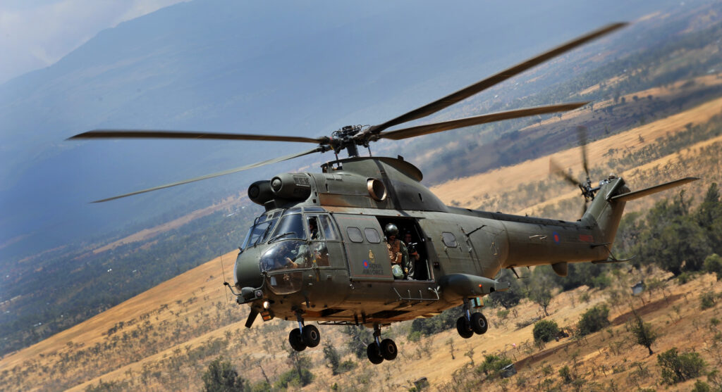 A Puma helicopter from the Royal Air Force flying over the Kenyan plains.