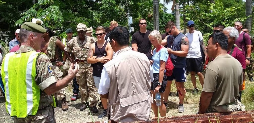 Major Alan Grant is pictured with a colleague and several people providing a safety briefing for the exercise. 