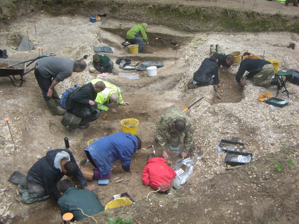 Pictured are 13 people including veterans from Operation Nightingale who were injured in war working on an excavation dig at Salisbury Plain. 