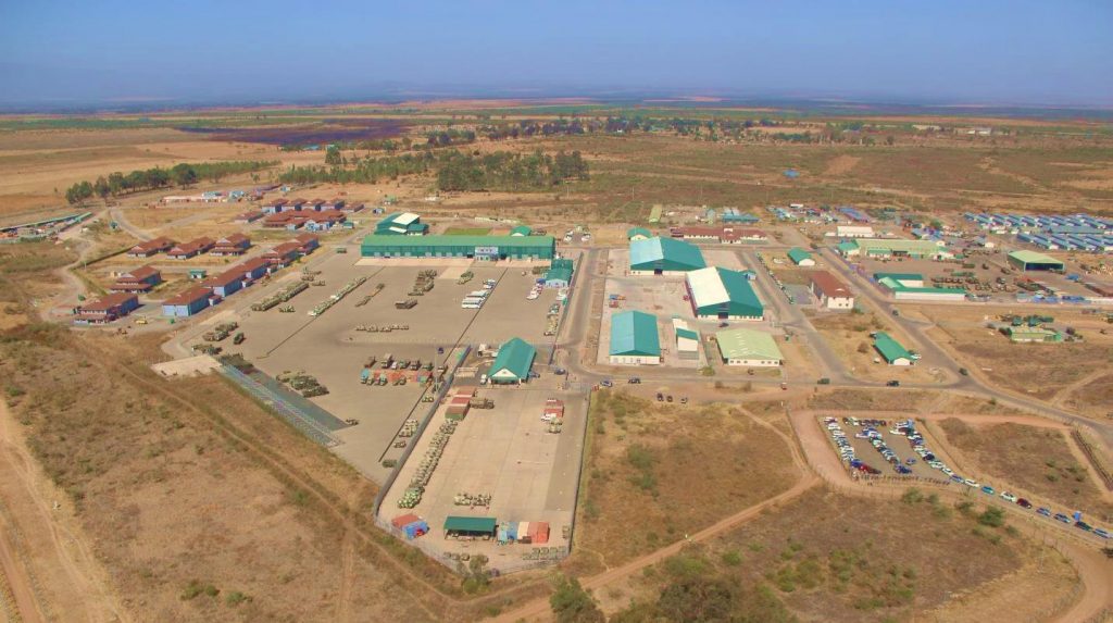 A view from the air looking down at Nyati Barracks. There are a range of buildings spread out over a large, flat area and surrounded mostly by brown earth. 