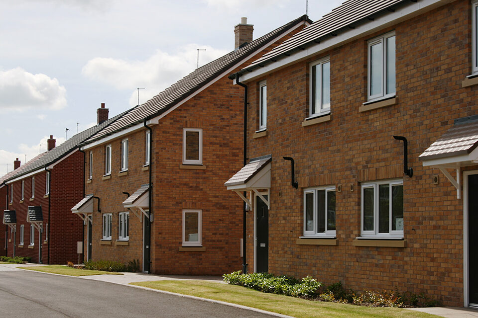 A row of semi detached brick houses.