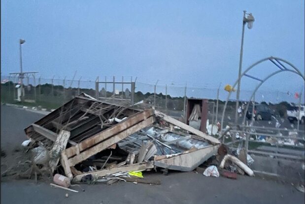 A pile of debris on a tarmac surface in the early morning.