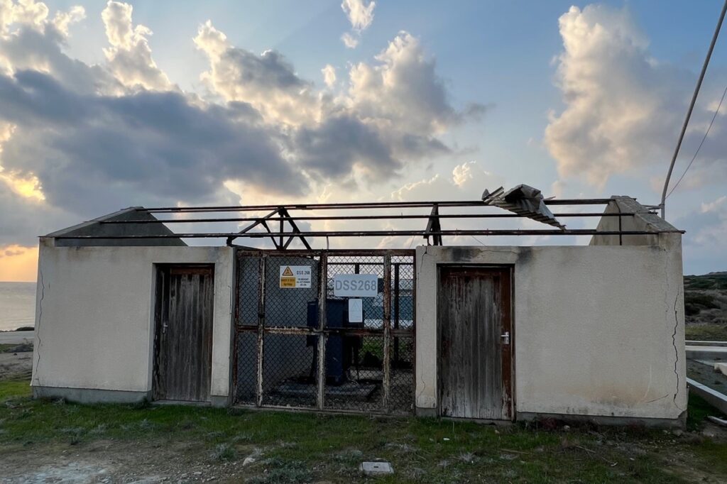 The roof entirely ripped off a small building.