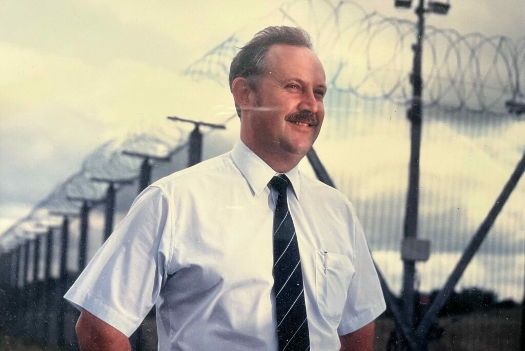 An old photograph of Tom Meadows in uniform while working on site for the Security Services Group