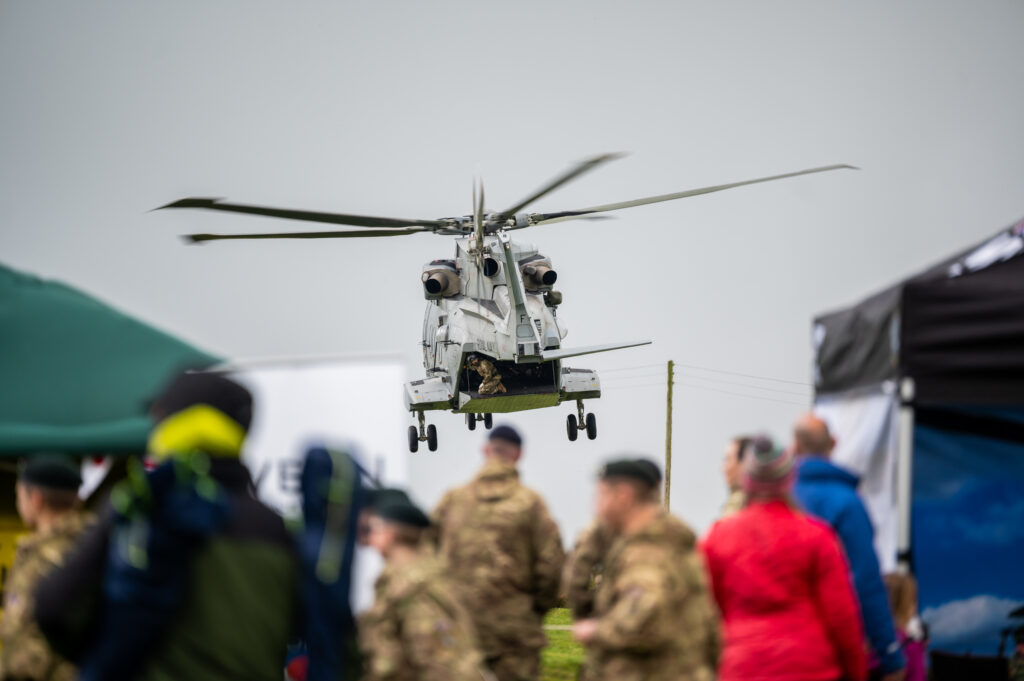 A helicopter flies over a group of people